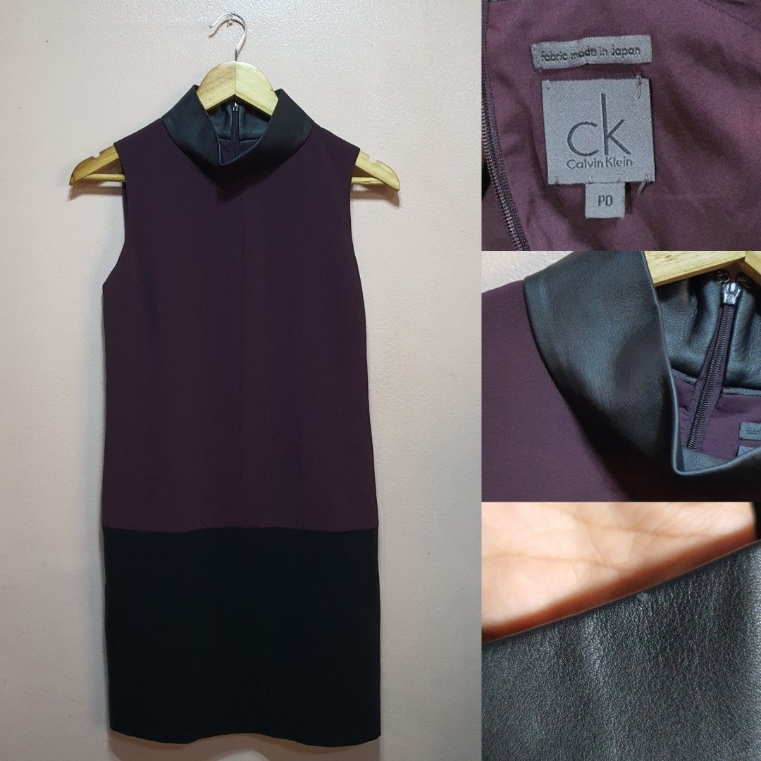 Calvin Klein Sleeveless Dress (Category: Dresses) located in Baguio. Submitted by dauntlessph (Listing ID 1408615678, Image 1). Description: - Calvin Klein sleeveless dress - Two-tone design: dark purple upper, black lower - Features a mock neck with leather-like material - Made in Japan - Back zipper closure.