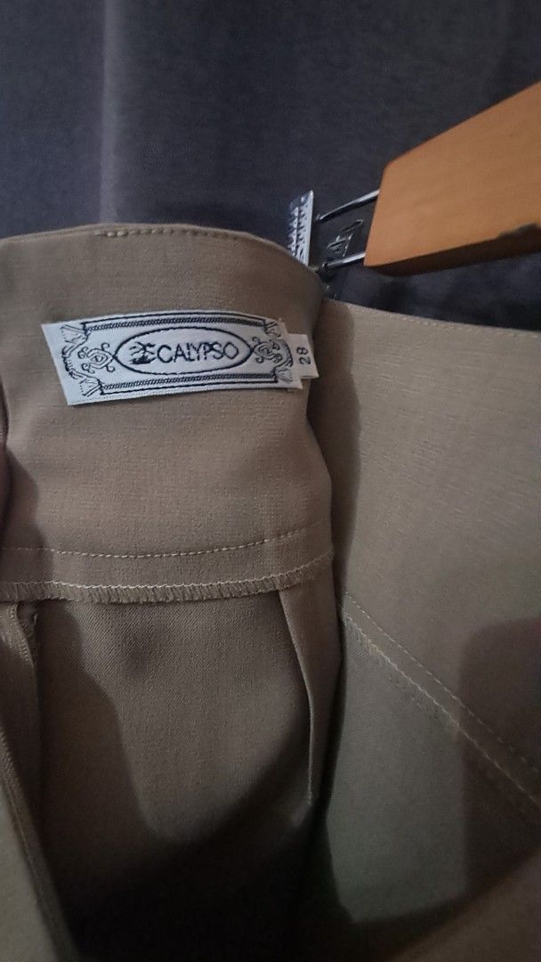 Calypso Beige pencil cut Skirt (Category: Skirts) located in Las Pinas. Submitted by beng2024 (Listing ID 1408569011, Image 3). Description: - Calypso beige pencit cut skirt - waist Size 28 but can fit up to 30 - hips up to 39" -length 22" - Zipper closure at the back with slit - Simple design - Suitable for various occasions - Made of smooth, likely woven fabric, no inner lining.