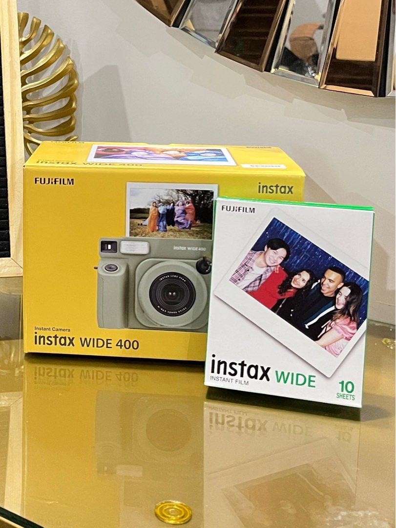 Fujifilm Instax Wide 400 Camera (Category: Cameras) located in Malolos. Submitted by sshoooo (Listing ID 1408543430, Image 2). Description: - Fujifilm Instax Wide 400 instant camera - Includes camera and a pack of Instax Wide film (10 sheets) - Brand new, in original packaging - Box features camera model and sample photo - Film pack shows a group photo - Designed for wide-format instant photos.