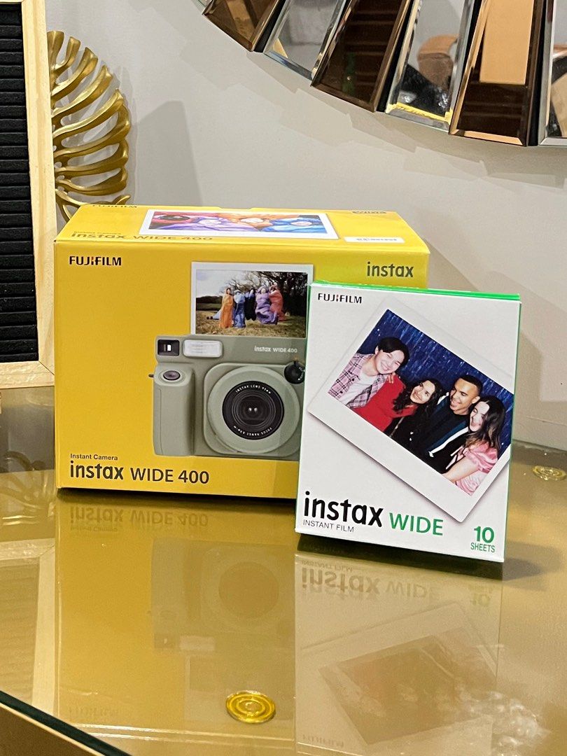 Fujifilm Instax Wide 400 Camera (Category: Cameras) located in Malolos. Submitted by sshoooo (Listing ID 1408543430, Image 1). Description: - Fujifilm Instax Wide 400 instant camera - Includes camera and a pack of Instax Wide film (10 sheets) - Brand new, in original packaging - Box features camera model and sample photo - Film pack shows a group photo - Designed for wide-format instant photos.