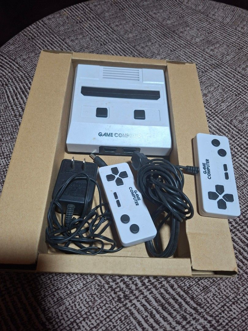 Game Computer Console (sold as-is) untested (Category: Others) located in Bulacan. Submitted by ourdailyfinds (Listing ID 1408557535, Image 2). Description: Retro Game Computer Set – Japan Surplus Find! (UNTES­TED) Looking for a cool vintage piece? This old game computer is perfect for collectors, display, or restoration projects! 📦 Inclusions Console unit 2 controllers Power adapter Working condition NOT tested – sold AS IS ✨ Highlights White c