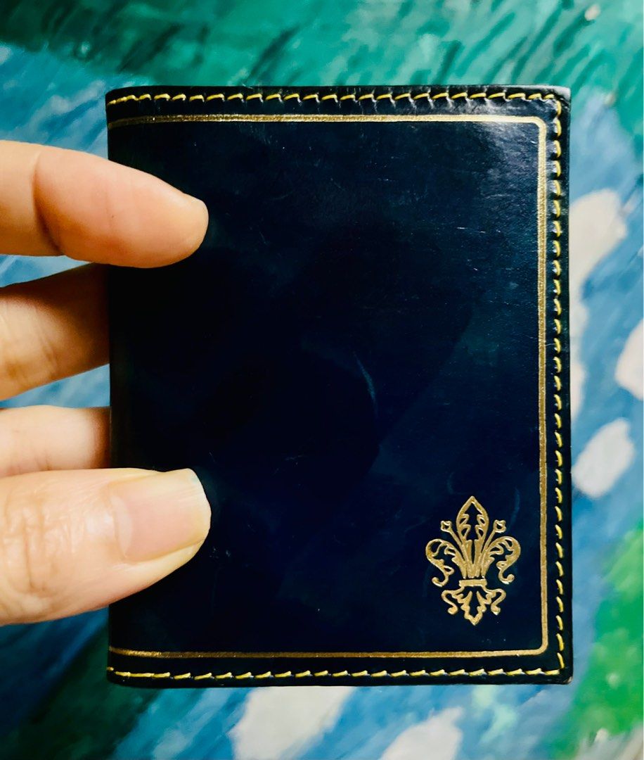 Genuine Leather Card Holder (Category: Wallets & Card holders) located in Antipolo. Submitted by MSelection (Listing ID 1408694705, Image 1). Description: - Genuine leather card holder - Navy blue exterior with gold accents - Features multiple card slots - Tan leather lining - Made in Florence - Decorative emblem.