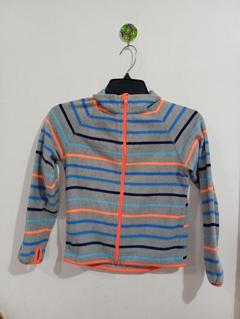 H&M Sport Fleece Jacket (Category: Babies & Kids Fashion) located in Muntinlupa City. Submitted by challasy (Listing ID 1408653703, Image 3). Description: Unsued/New Php 350 H&M Sport fleece jacket with a full zip closure. Features a grey base with blue and orange stripes. The jacket has a stand-up collar and long sleeves. The size is indicated as EUR 122/128, US 6-8Y, CA 6-8A, CN 130/64, MX 122/128, and AUS 7-8. Muntinlupa City.