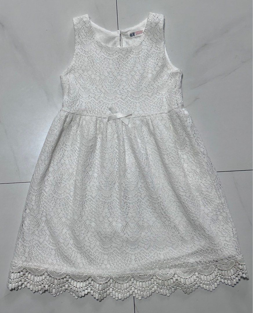 H&M White Lace Dress (Category: Babies & Kids Fashion) located in Manila. Submitted by chamwel (Listing ID 1408539028, Image 1). Description: - H&M white lace dress - Sleeveless design - Round neckline - Small bow detail at the waist - Scalloped lace trim at the hem - Perfect for special occasions -see photo for reference.