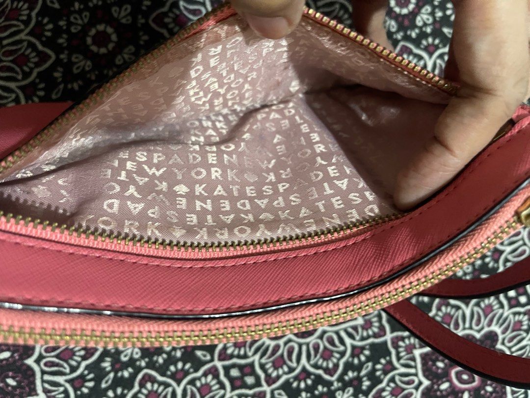 Kate Spade Pink Clutch (Category: Clutches) located in Quezon City. Submitted by minekoh21 (Listing ID 1408580771, Image 2). Description: - Compact / small clutch size — easy to carry for evenings or light outings - Made of leather exterior for a classy, refined look - Zip closure to keep contents secure - Elegant hardware for a polished finishing touch - Enough internal space for essentials (cards, phone, small items) without bulk — ideal for ni