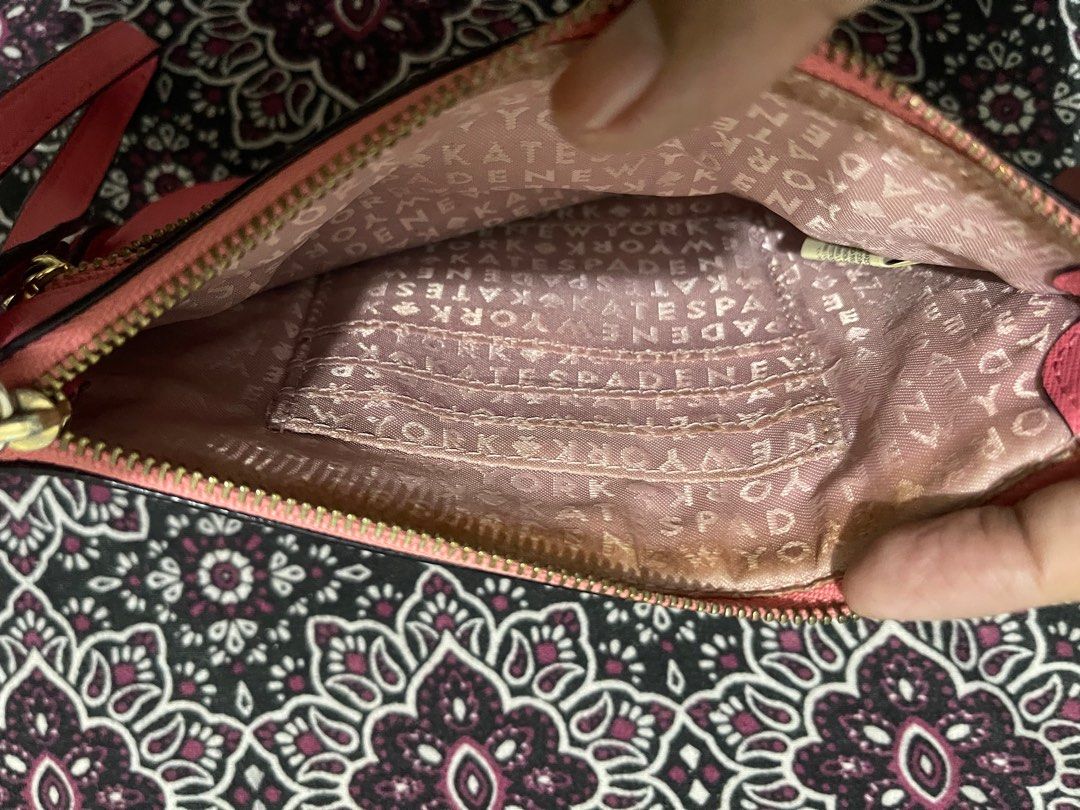 Kate Spade Pink Clutch (Category: Clutches) located in Quezon City. Submitted by minekoh21 (Listing ID 1408580771, Image 3). Description: - Compact / small clutch size — easy to carry for evenings or light outings - Made of leather exterior for a classy, refined look - Zip closure to keep contents secure - Elegant hardware for a polished finishing touch - Enough internal space for essentials (cards, phone, small items) without bulk — ideal for ni