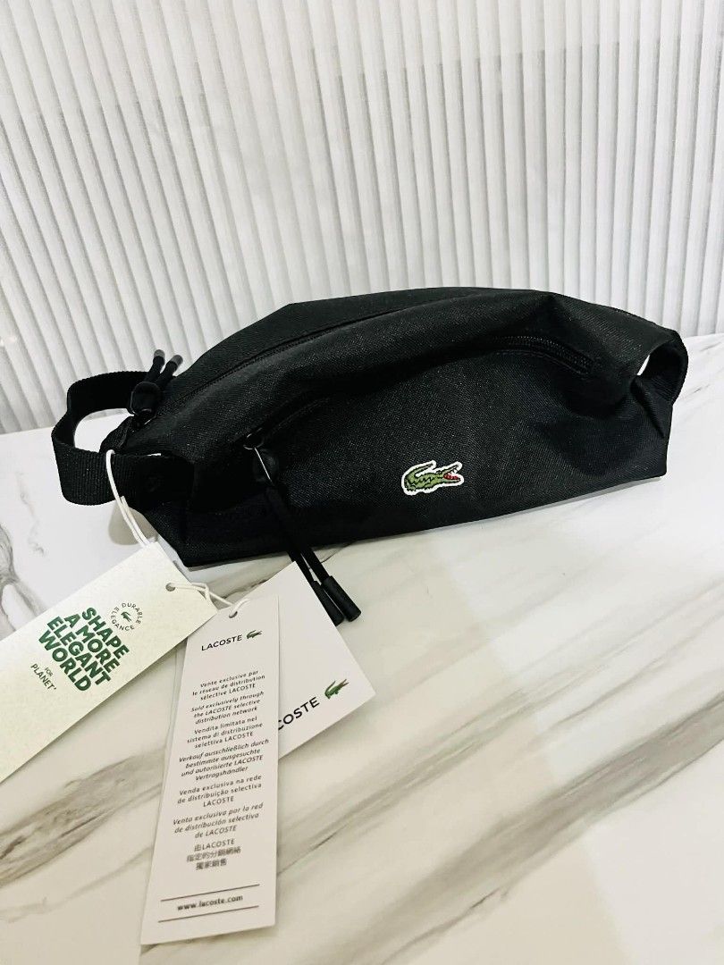 Lacoste Black Unisex Sling Bag (Category: Belt bags, Clutches and Pouches) located in Manila. Submitted by keith_ul (Listing ID 1408562201, Image 1). Description: - Authentic Lacoste unisex toiletry bag - Color: Black - Features the iconic Lacoste crocodile logo - Zippered closure - Includes a strap - Comes with original tags - Color code: Robert Georges Vert - N30.