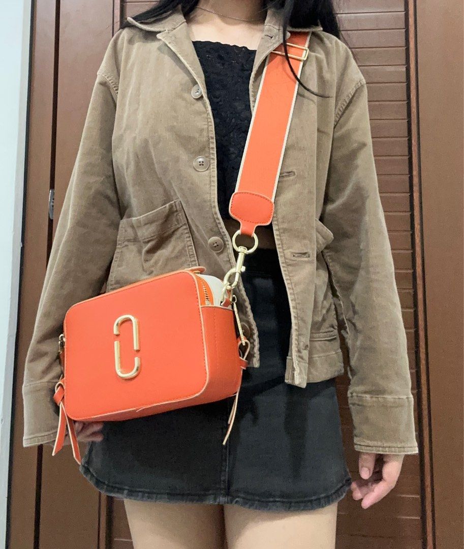Marc Jacobs The Box Bag (Category: Luxury Bags & Wallets) located in Manila. Submitted by rfibe (Listing ID 1408668583, Image 1). Description: - Orange Marc Jacobs The Box Bag - Detachable orange and white strap - Gold-tone logo and hardware - Rectangular shape with zip closure - Features a small leather tassel - Worn crossbody - has flaws, dm me.