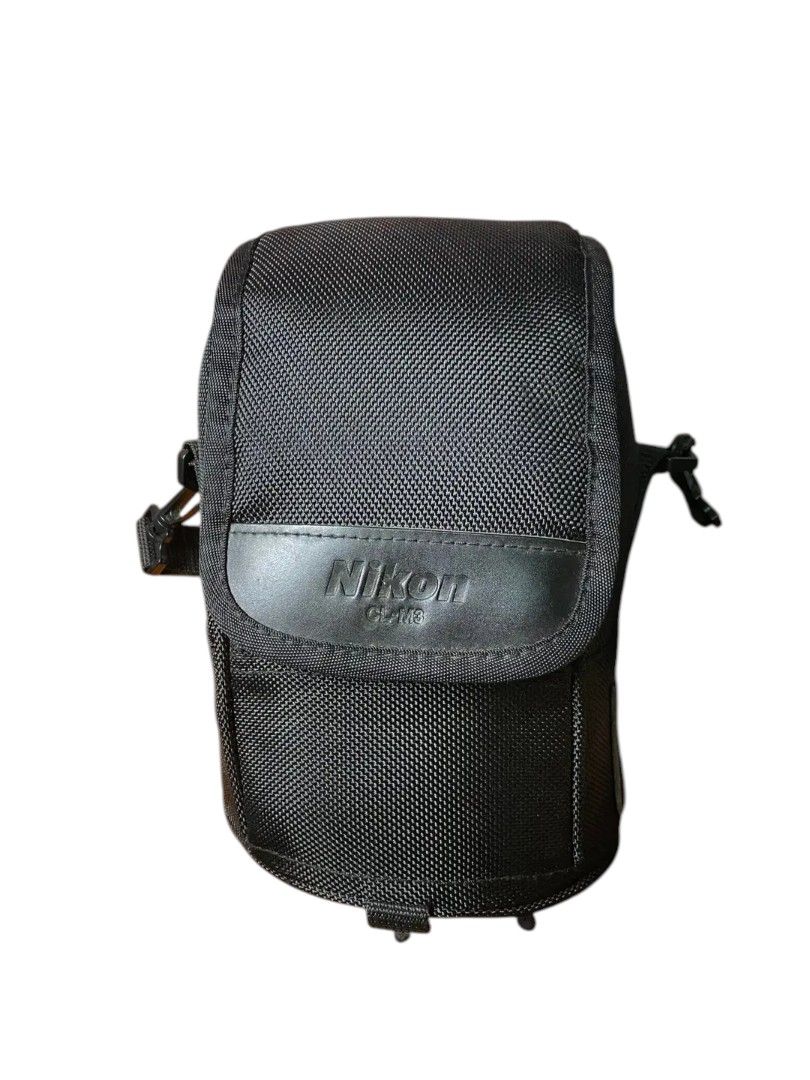 Nikon Cam Bag (Category: Camera Bags & Carriers) located in Andop. Submitted by source8600 (Listing ID 1408674980, Image 1). Description: It is a replacement case for the Nikon AF-S NIKKOR 14-24mm f/2.8G and AF-S NIKKOR 24-70mm f/2.8G lenses. The case is made of durable ballistic nylon material. It features a padded interior to protect lenses from shocks and scratches. The case includes a secure hook and loop fastener and an attached carrying str