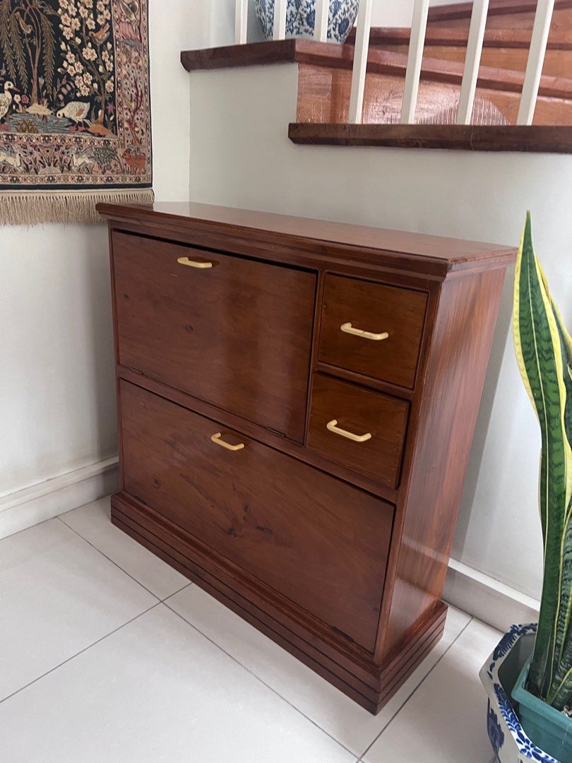 Red Narra Solid Wooden Shoe Cabinet with Drawers (Category: Shelves, Cabinets & Racks) located in Makati City. Submitted by pbkfurnitureandgoods (Listing ID 1408543255, Image 2). Description: - Elegant wooden shoe cabinet - Dark wood finish with gold-toned handles - Multiple compartments and drawers - Ample storage space for shoes - Stylish design for any entryway or bedroom - Includes two pull-down compartments and two drawers.