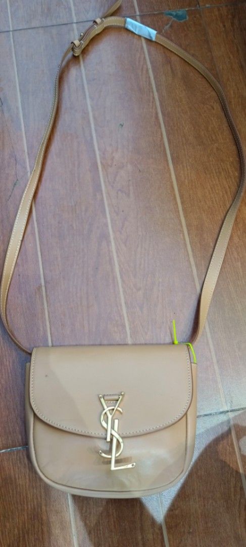Saint Laurent YSL Crossbody Bag (Category: Luxury Bags & Wallets) located in Legazpi City. Submitted by georgepineda791 (Listing ID 1408502349, Image 1). Description: - Saint Laurent crossbody bag - Color: Light Brown - Iconic YSL logo - Made in Italy - Long strap for shoulder/crossbody wear - Interior: Matching light brown - Condition: Good.