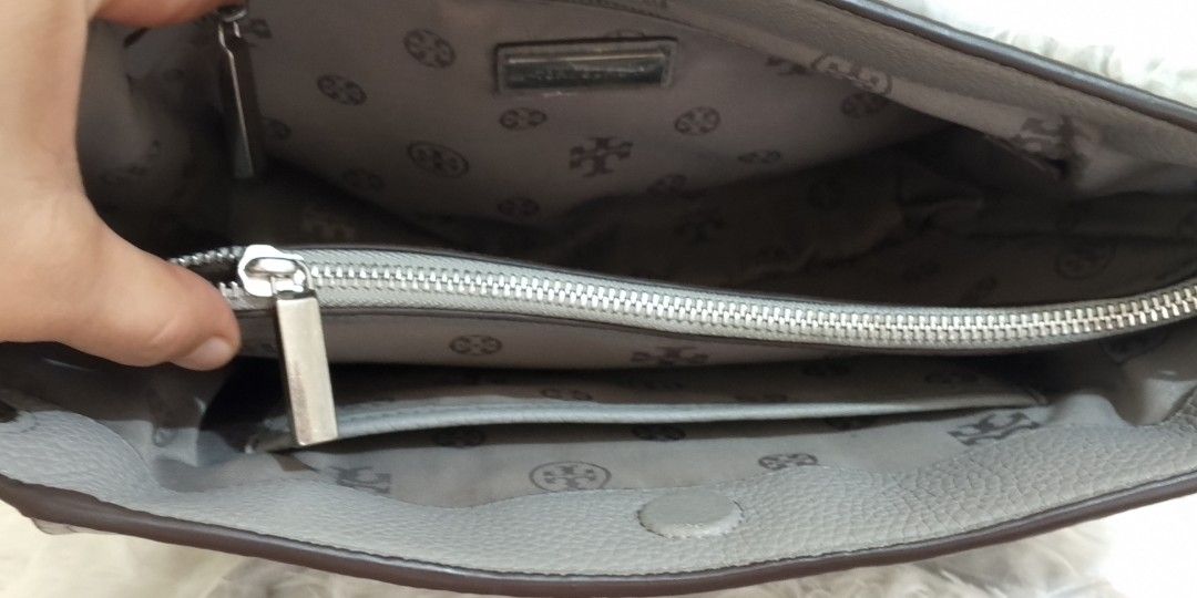 Tory Burch Gray Tote Bag in pebbled (Category: Luxury Bags & Wallets) located in Bacolor. Submitted by pinktintmine (Listing ID 1408561706, Image 2). Description: - Gray Tory Burch tote bag - Silver chain straps - Silver Tory Burch logo - Includes a long strap - Made of leather.