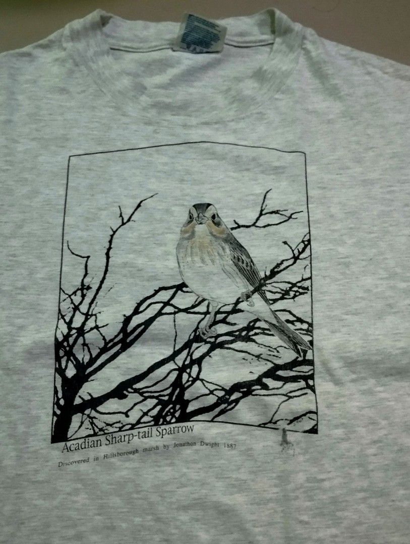 Vintage Acadian Sharp-tail Sparrow Shirt (Category: Tshirts & Polo Shirts ) located in Manila. Submitted by darth3pter (Listing ID 1408563530, Image 2). Description: - Hanes Beefy-T shirt - Features a graphic of an Acadian Sharp-tail Sparrow photograph 1887 by Jonathon Dwight - Color: Light gray - Size: L 21/29 - Material: 99% cotton, 1% other fibers - Graphic: Black and white illustration of the bird on a branch.