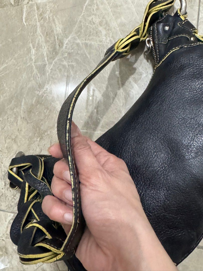 Vintage MCM black leather shoulder bag. (Category: Luxury Bags & Wallets) located in Cavite. Submitted by edendardar07 (Listing ID 1408687120, Image 3). Description: Shoulder bag with yellow contrast stitching and braided strap detail. 6/10 Silver Hardware 85% Rubs on lining.