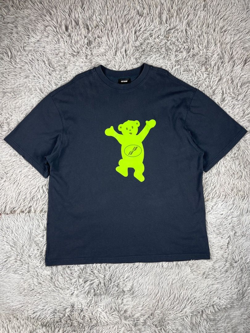 We11done Bear Graphic T-shirt (Category: Luxury Apparel) located in Cebu City. Submitted by kayekallie (Listing ID 1408657637, Image 3). Description: Navy blue We11done T-shirt featuring a neon green bear graphic on the front and back. The shirt has a crew neck and short sleeves. The size is L. The tag is visible, showing the brand and model number. The shirt has a small black label near the bottom hem. Width 24 Length 29.5.