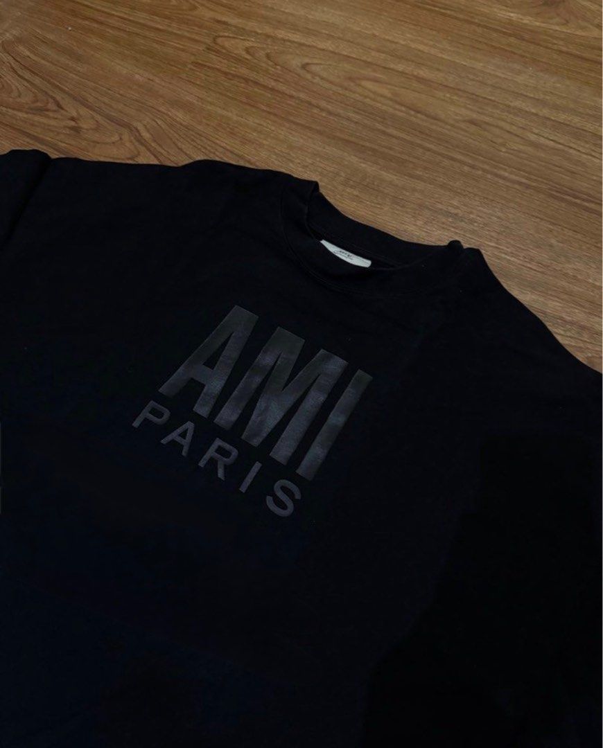 AMI Paris Black Logo T-shirt (Category: Tshirts & Polo Shirts ) located in Paranaque City. Submitted by declutterhead (Listing ID 1408477374, Image 2). Description: - AMI Paris Shirt Thrifted - Large logo print on the front - Classic crew neck design - Short sleeves - Made from soft, comfortable material - Versatile for everyday wear.