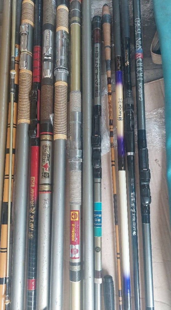 Assorted Fishing Rods (15 pcs) (Category: Fishing) located in Bulacan. Submitted by ourdailyfinds (Listing ID 1408840300, Image 1). Description: Collection of various fishing rods. Includes rods of different lengths and designs, some with visible brand markings. Also includes rod holders and a carrying case. The rods appear to be made of different materials, including carbon fiber. Some rods have visible reel seats and guides. Notes: Payment: GCa