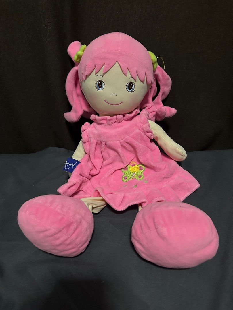 Blue Magic “Chelsea” Pink Plush Doll (Category: Plushies & Soft Toys) located in Santa Rita. Submitted by john_valencia02 (Listing ID 1408796134, Image 1). Description: - Adorable pink plush doll - Sweet face with curly pigtails - Features a pink dress with butterfly design - Soft, plush arms and large feet - Includes attached tag - Ideal for cuddling or decoration Loc: Pampanga.