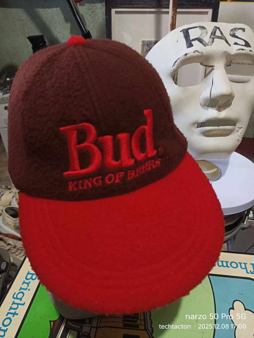 Budweiser King of Beers Cap (Category: Caps & Hats) located in Santo Tomas. Submitted by pickers_corner (Listing ID 1408712785, Image 1). Description: Vintage Budweiser cap featuring a red and brown color scheme. The front displays the "Bud" logo with "King of Beers" underneath. The side of the cap has a Budweiser logo. It has an adjustable strap at the back..