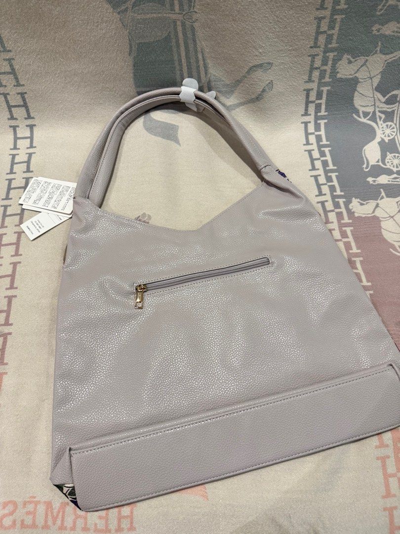 Floral Print Shoulder Bag with Gray Straps (Category: Shoulder Bags) located in San Fernando. Submitted by swiftforest13 (Listing ID 1408728551, Image 2). Description: - Brand new shoulder bag - Eye-catching floral print on the front - Solid gray back - Comfortable gray straps - Secure zipper closure on the back - Includes original tags.