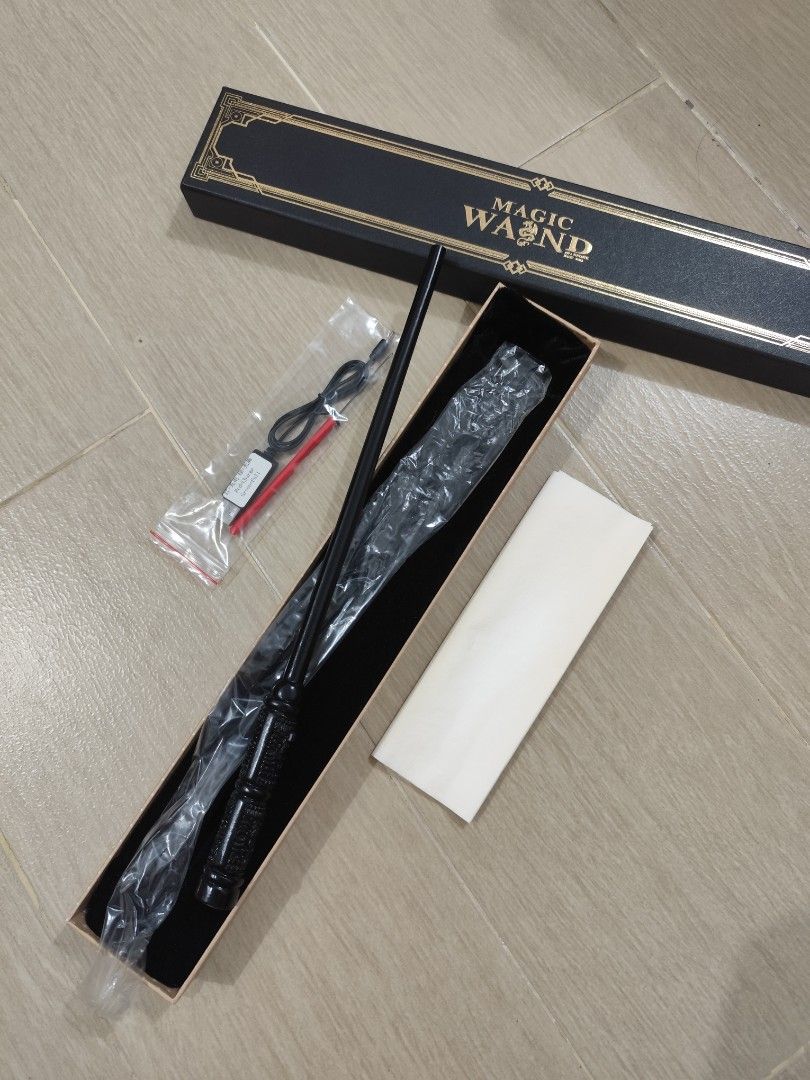 HARRY POTTER WAND - Magic Wand with Box (Category: Western Merchandise) located in Taguig. Submitted by emmanskie10 (Listing ID 1408740673, Image 1). Description: - Black magic wand - Harry Potter Wand - Detailed handle - Includes box and charging cable - used only once - Perfect for cosplay or gifts - Great for Harry Potter fans.