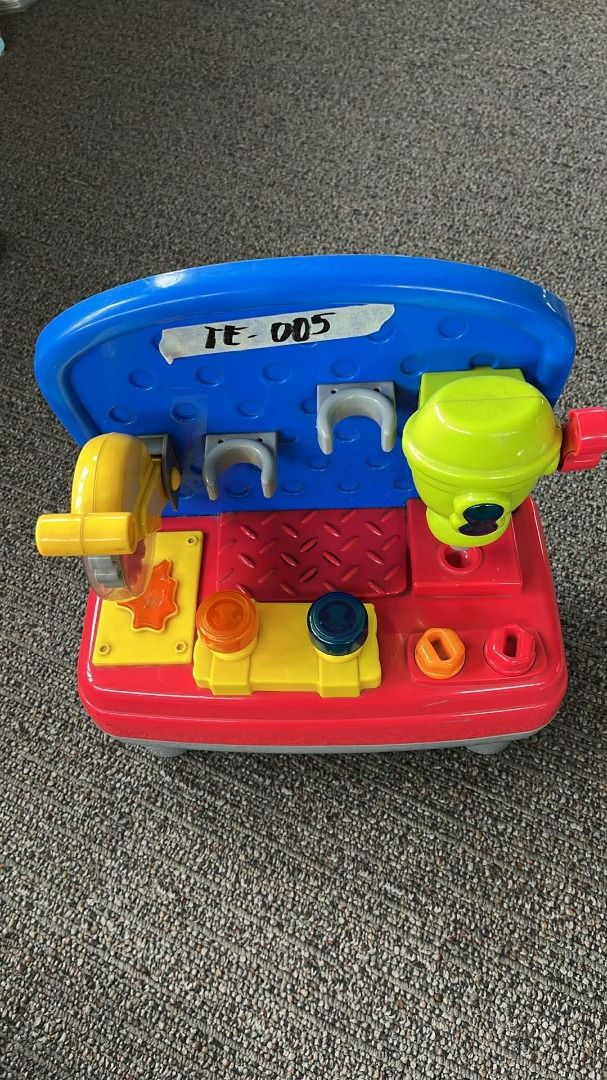 Mini Work Bench (Category: Kids Toys) located in Subic. Submitted by malojod2334612 (Listing ID 1408751972, Image 1). Description: - Without Tools - Colorful toy workbench for kids - Includes a saw, drill, and other accessories - Features a blue top with storage - Red base with yellow and orange details - Designed for imaginative play and learning about tools.