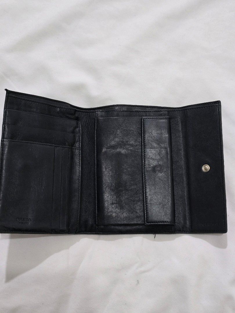 Original Prada Tessuto x Leather Bifold Wallet (Category: Luxury Bags & Wallets) located in Cavite. Submitted by everythingjapan (Listing ID 1408875578, Image 3). Description: heavily used original Prada bifold wallet obvious signs of wear but it can still be used as is zipped back pocket 6 card slots 2 open pockets coin pocket bill compartment dimensions: 6 x 4 inches.