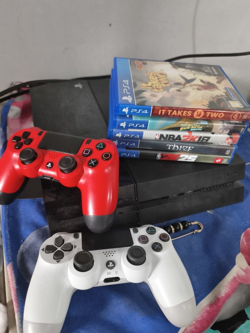 PlayStation 4 Console with Games and Controllers (Category: PlayStation) located in Quezon City. Submitted by hghthrft (Listing ID 1408739444, Image 2). Description: - PlayStation 4 console included - Two controllers: white and red - Games: NBA 2K25, It Takes Two, Thief - All items in good working condition.