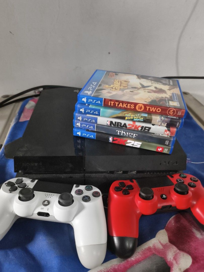 PlayStation 4 Console with Games and Controllers (Category: PlayStation) located in Quezon City. Submitted by hghthrft (Listing ID 1408739444, Image 1). Description: - PlayStation 4 console included - Two controllers: white and red - Games: NBA 2K25, It Takes Two, Thief - All items in good working condition.