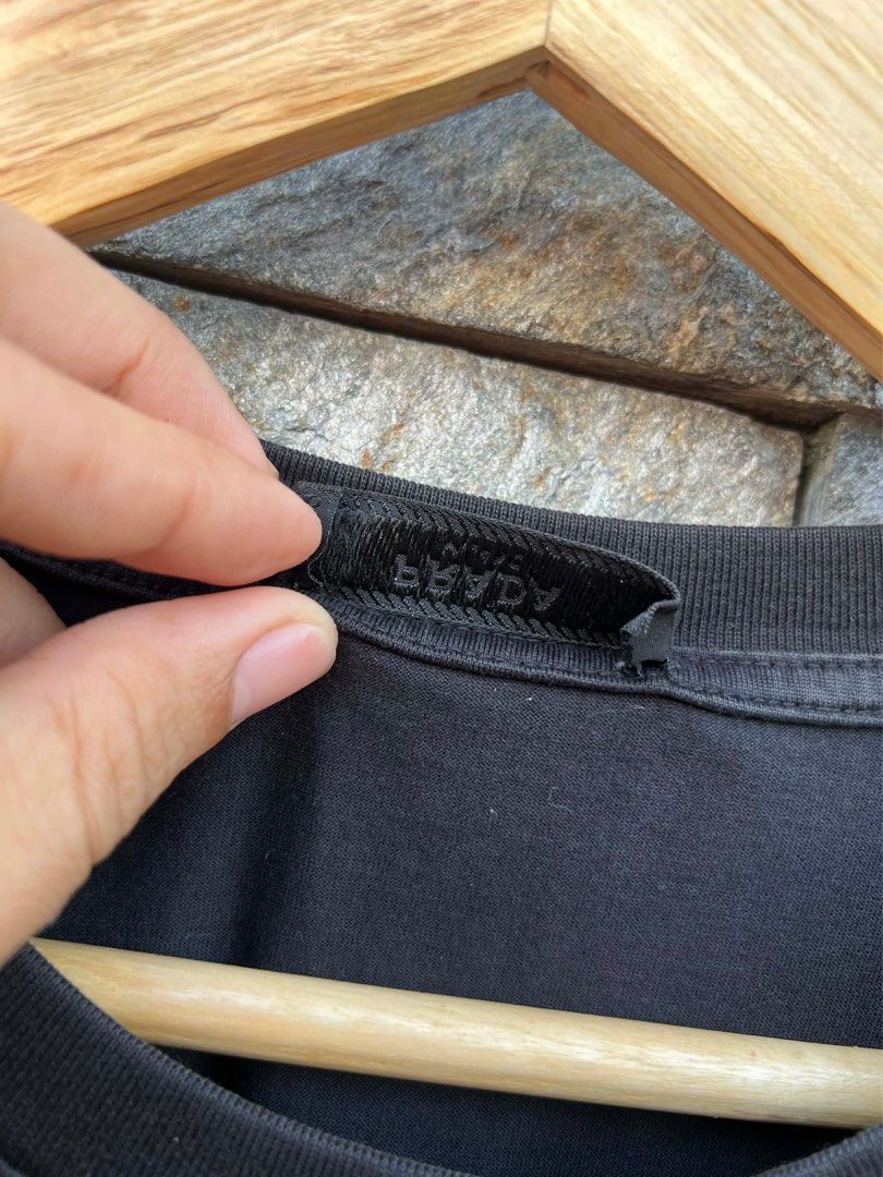 Prada Black Pocket T-shirt (Category: Luxury Apparel) located in Bacolod City. Submitted by novymaesel14868 (Listing ID 1408700556, Image 3). Description: - Prada black t-shirt - Chest pocket with Prada logo - Silver button closure on pocket - Crew neck and short sleeves - Made in Indonesia - Fabric: 100% cotton Size XL Dimes 22x28 Excellent Condition DM to Purchase 📩.