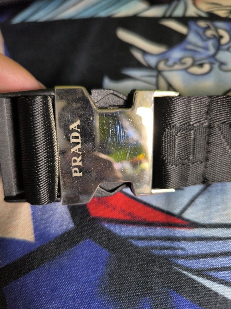 Prada Black Waist Bag (Category: Luxury Bags & Wallets) located in Rizal. Submitted by archive_silhouette (Listing ID 1408723073, Image 3). Description: - Prada waist bag - Color: Black - Features two pouches - Silver-tone buckle with Prada logo - Prada logo embossed interior - Includes chain and strap with Prada logo - Made in Italy.