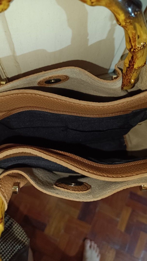 Tan Leather Handbag with Bamboo Handles (Category: Cross-body Bags) located in Valenzuela. Submitted by just_m33 (Listing ID 1408809089, Image 2). Description: - Tan leather handbag - Bamboo handles - Detachable shoulder strap - Gold-toned hardware - Zippered main compartment - Interior pocket - Black interior lining - Structured shape - Textured leather material *Lightly used. In excellent condition. *Make an offer. Negotiable.