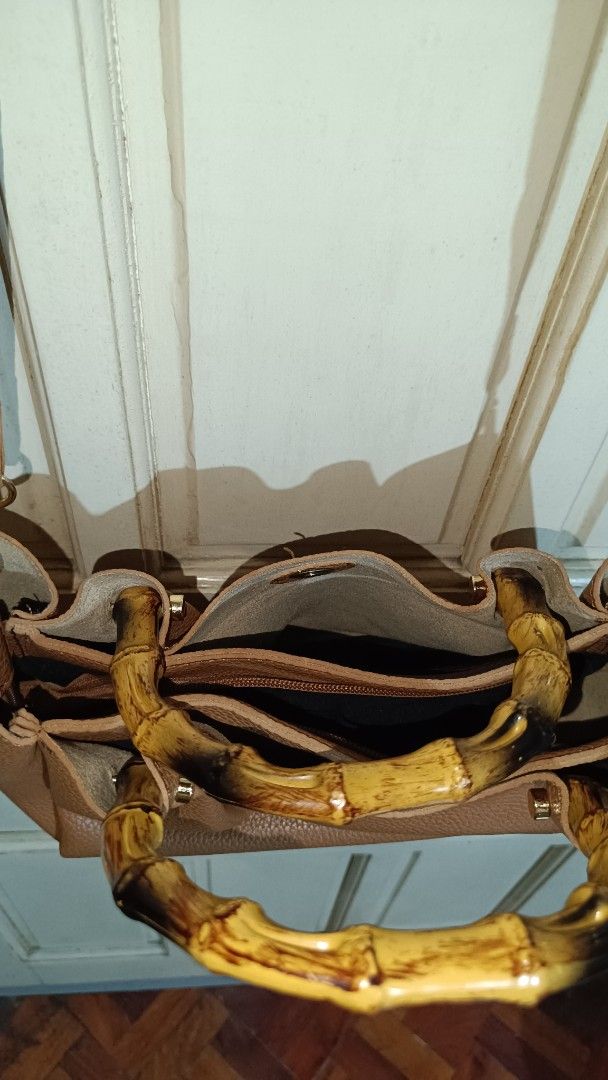 Tan Leather Handbag with Bamboo Handles (Category: Cross-body Bags) located in Valenzuela. Submitted by just_m33 (Listing ID 1408809089, Image 3). Description: - Tan leather handbag - Bamboo handles - Detachable shoulder strap - Gold-toned hardware - Zippered main compartment - Interior pocket - Black interior lining - Structured shape - Textured leather material *Lightly used. In excellent condition. *Make an offer. Negotiable.