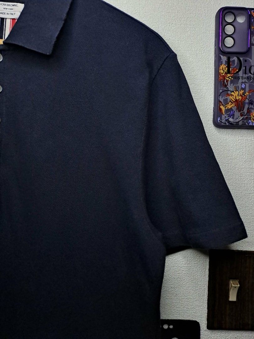 Thom Browne RWB Pique Polo Shirt (Category: Luxury Apparel) located in Quezon City. Submitted by yaseen73 (Listing ID 1408770154, Image 2). Description: Authentic Thom Browne RWB Cotton piqué polo Made in Italy · Rib knit spread collar · Five-button placket · Logo patch at front · Button vent at droptail hem · Rib knit tricolor trim at back · Tricolor grosgrain flag at back Supplier Color: Navy Gender: Mens Size # 3 Dimensions: W21 x L28½ °Missin