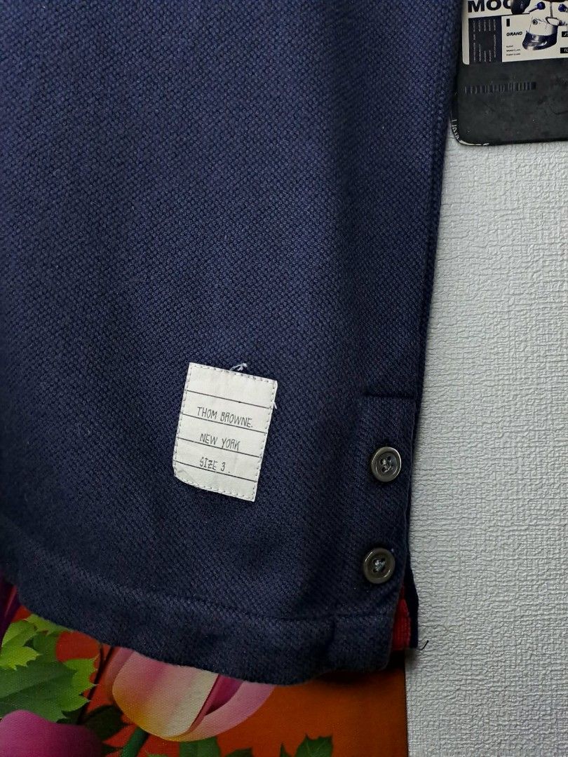 Thom Browne RWB Pique Polo Shirt (Category: Luxury Apparel) located in Quezon City. Submitted by yaseen73 (Listing ID 1408770154, Image 3). Description: Authentic Thom Browne RWB Cotton piqué polo Made in Italy · Rib knit spread collar · Five-button placket · Logo patch at front · Button vent at droptail hem · Rib knit tricolor trim at back · Tricolor grosgrain flag at back Supplier Color: Navy Gender: Mens Size # 3 Dimensions: W21 x L28½ °Missin