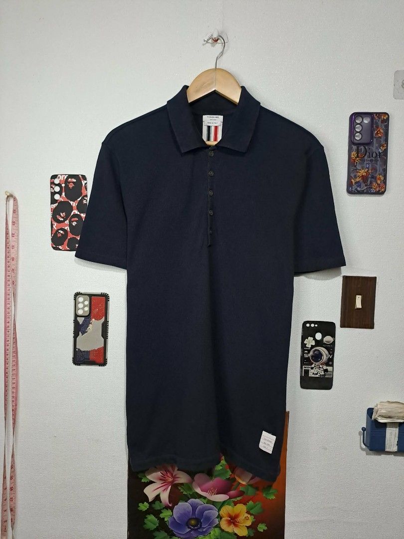 Thom Browne RWB Pique Polo Shirt (Category: Luxury Apparel) located in Quezon City. Submitted by yaseen73 (Listing ID 1408770154, Image 1). Description: Authentic Thom Browne RWB Cotton piqué polo Made in Italy · Rib knit spread collar · Five-button placket · Logo patch at front · Button vent at droptail hem · Rib knit tricolor trim at back · Tricolor grosgrain flag at back Supplier Color: Navy Gender: Mens Size # 3 Dimensions: W21 x L28½ °Missin