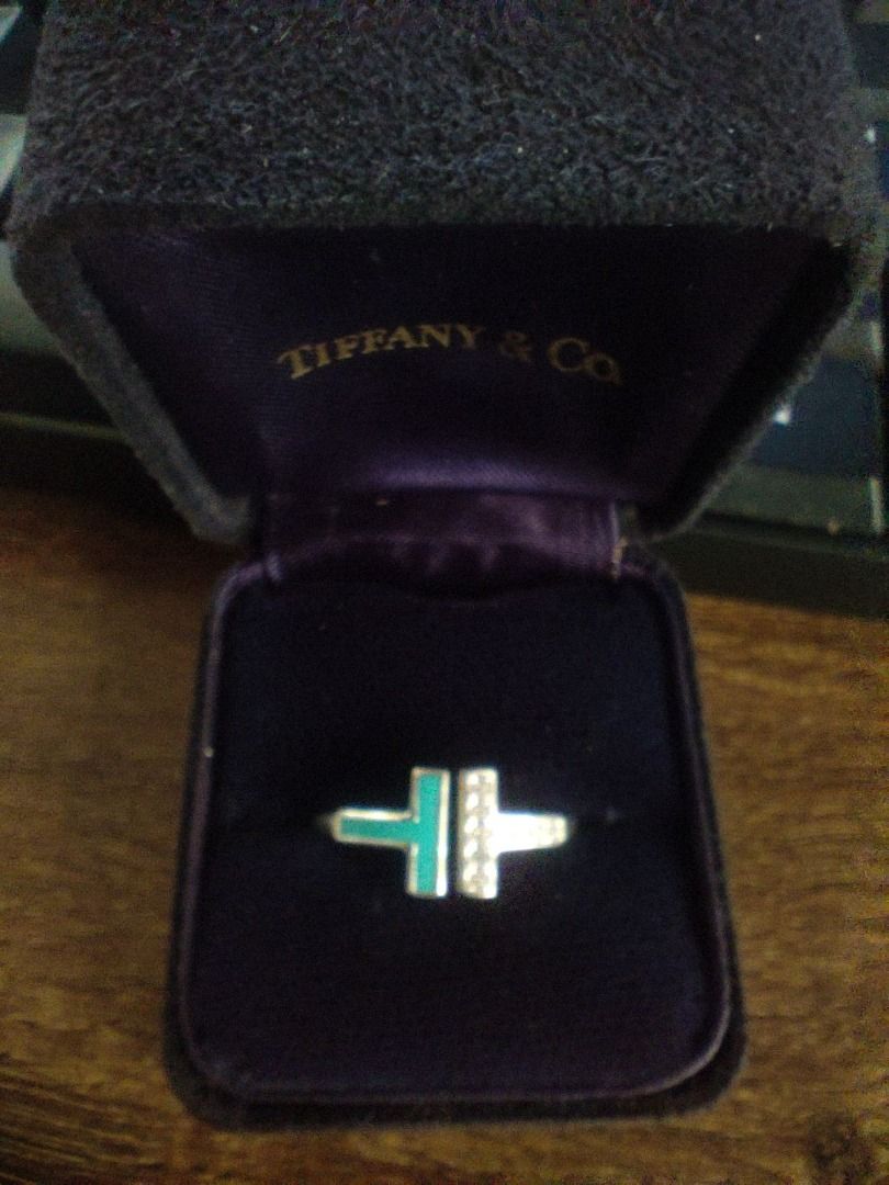 Tiffany & Co. T-Ring with Turquoise and Diamonds (Category: Rings) located in Legazpi City. Submitted by roxy420 (Listing ID 1408744827, Image 1). Description: Tiffany & Co. T-ring. Features a T-design with turquoise and diamond accents. The ring is marked "T & Co. Au750 Italy". Comes with the Tiffany & Co. box. A stylish and elegant piece perfect for everyday wear or special occasions..