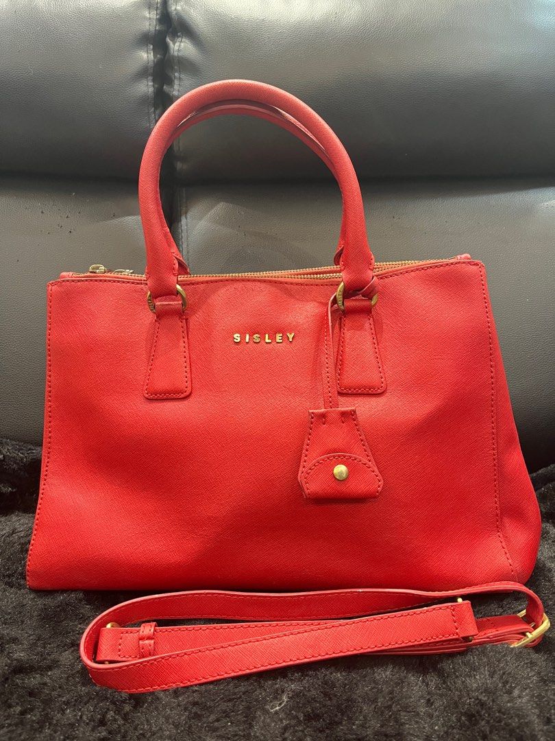 Sisley Red Two-Way Handbag Tote Bag (Category: Luxury Bags & Wallets) located in Makati City. Submitted by yumiiichigo (Listing ID 1350640428, Image 1). Description: dm for more info ❤️ signs of usage metal hardware.