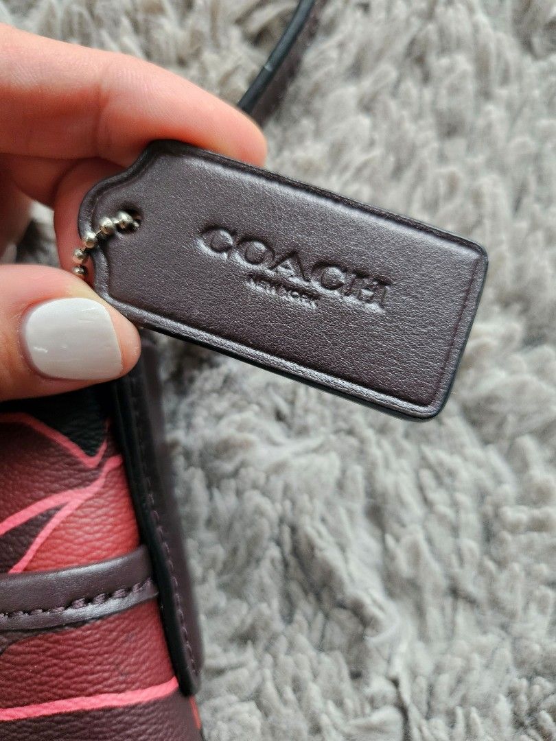 Coach File Crossbody Bag (Red Camo) (Category: Luxury Bags & Wallets) located in Marikina City. Submitted by aj.preloved (Listing ID 1352235486, Image 3). Description: Printed coated canvas with smooth leather details Zip-top closure, fabric lining Outside slip pocket Adjustable strap with 21 3/4" drop for shoulder or crossbody wear 10 1/4" (L) x 8 3/4" (H) x 2" (W).