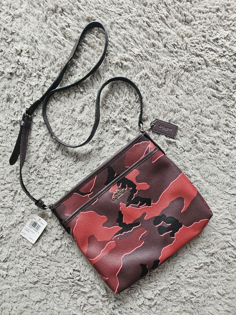 Coach File Crossbody Bag (Red Camo) (Category: Luxury Bags & Wallets) located in Marikina City. Submitted by aj.preloved (Listing ID 1352235486, Image 1). Description: Printed coated canvas with smooth leather details Zip-top closure, fabric lining Outside slip pocket Adjustable strap with 21 3/4" drop for shoulder or crossbody wear 10 1/4" (L) x 8 3/4" (H) x 2" (W).