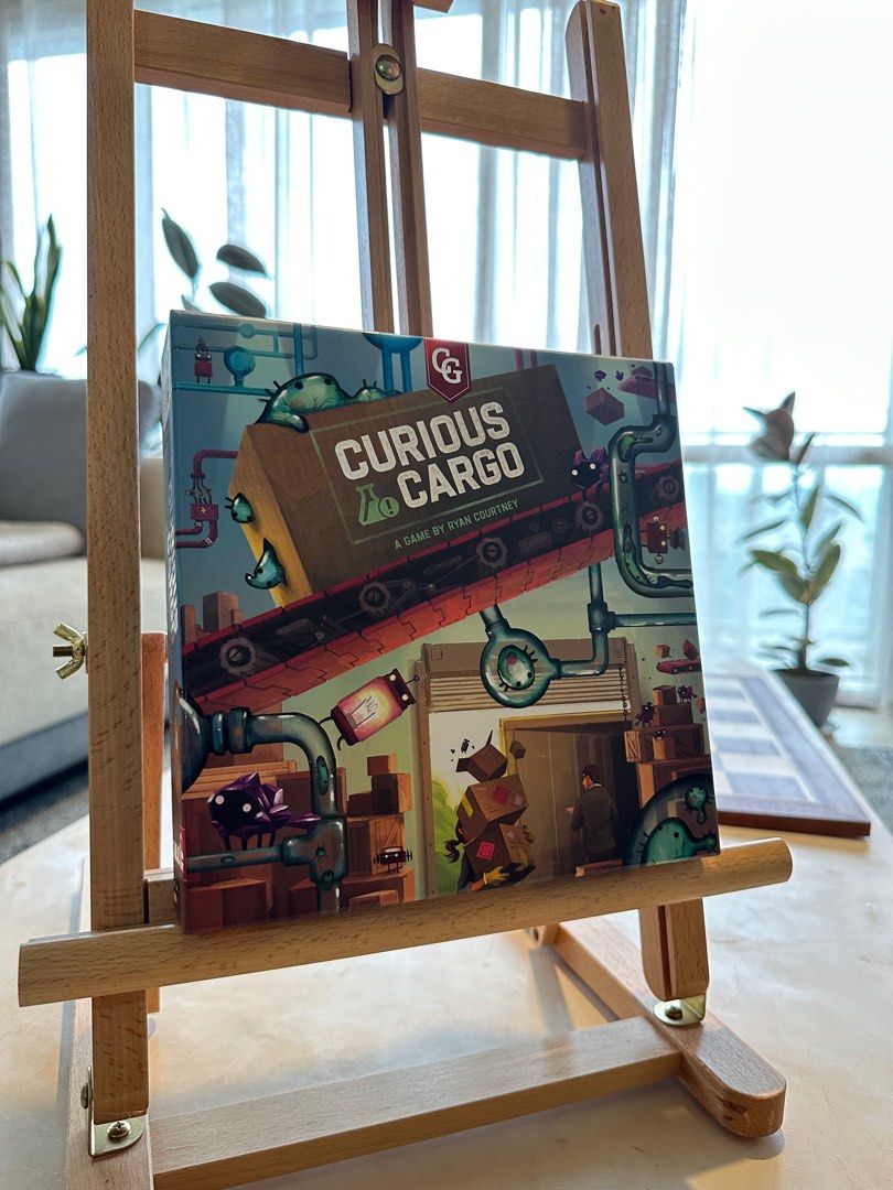 Curious Cargo 2-player Boardgame - Ready to Ship Goods? (Category: Board Games & Puzzles) located in Mandaluyong City. Submitted by jpetrulli (Listing ID 1352230932, Image 1). Description: Looking for a quirky and strategic two-player game? Curious Cargo, designed by Ryan Courtney (Pipeline), is a unique logistics and tile-laying game where you build conveyor belts, ship goods, and outmaneuver your opponent. With its deep strategy and engaging he