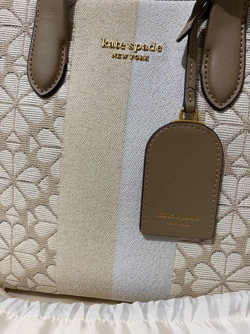 Kate Spade Manhattan Tote Bag (Category: Luxury Bags & Wallets) located in Zamboanga. Submitted by zamboutique (Listing ID 1352242974, Image 2). Description: Kate Spade Flower Jacquard Stripe Manhattan Small Tote Bag. Bought for PHP 24,525 last 2023 from Shangri-La. Complete. With receipt, dust bag. Will include paper bag if i find it 😁 THE DETAILS * Twill fabric with smooth leather trim * Faille lining * Plaque logo * Imported * Tote with open 