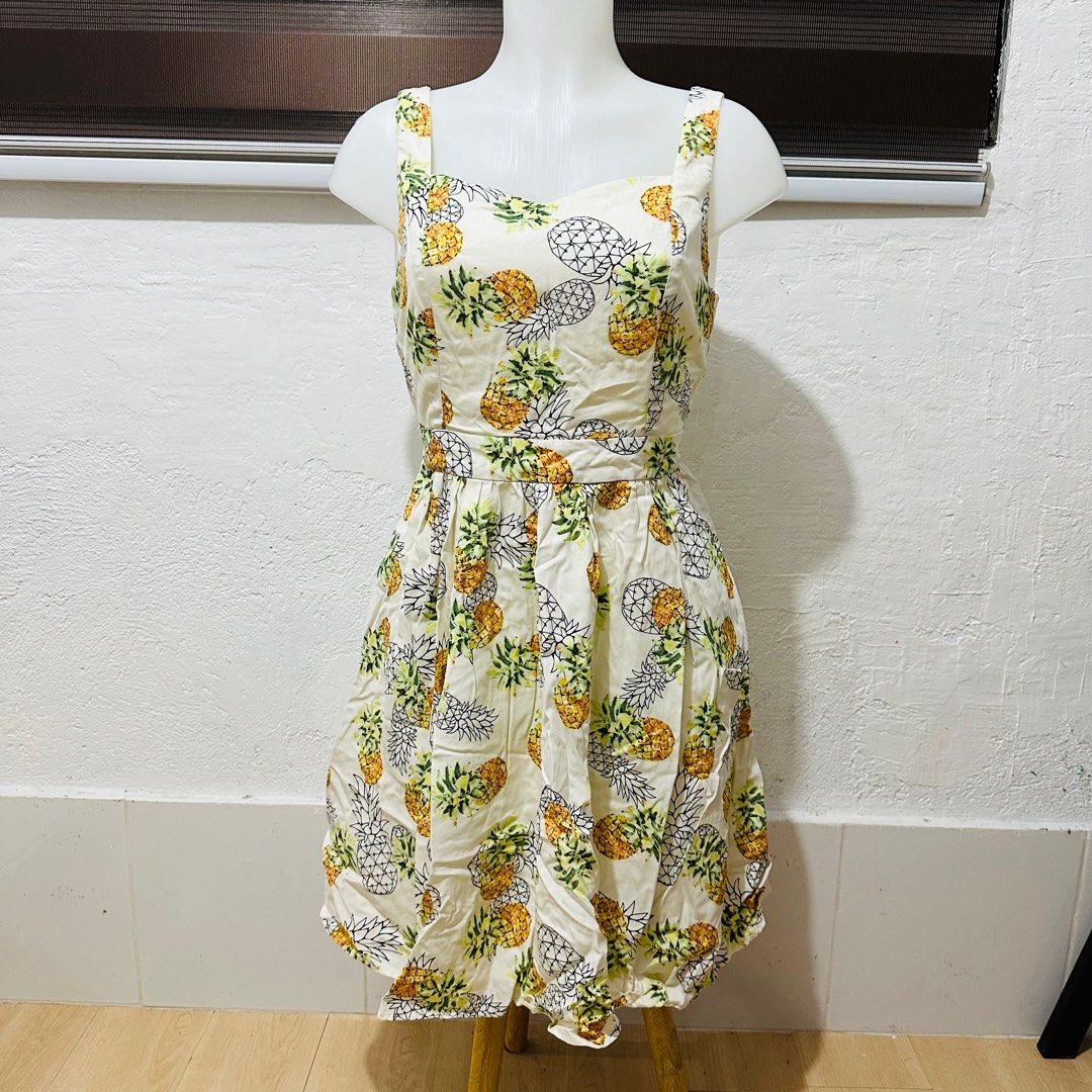 Pineapple Summer Dress (Category: Dresses) located in Calamba. Submitted by zybellezone (Listing ID 1352260509, Image 1). Description: Fits medium to large Criss cross back Double lining Minor flaw: hole in the inner lining, not seen when worn since it is inside.
