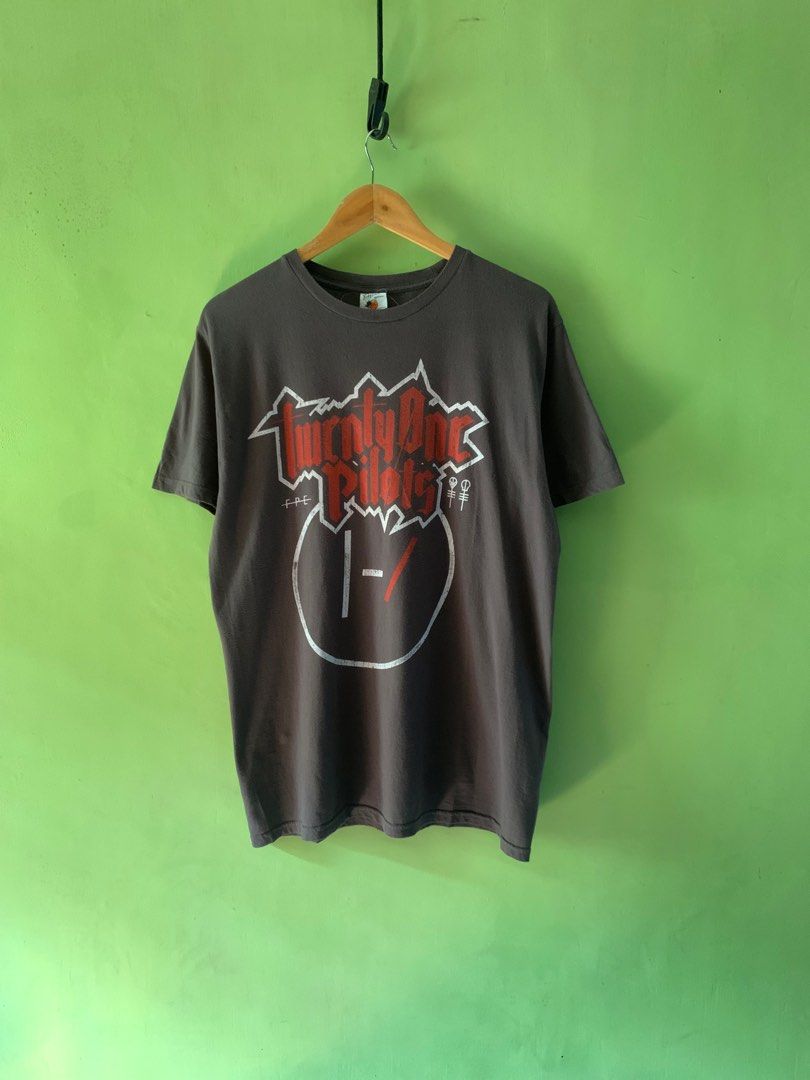 Y2K Twenty One pilots tee (Category: Tshirts & Polo Shirts ) located in Cagayan de Oro. Submitted by premium_thrifts (Listing ID 1352235605, Image 1). Description: Gray brown colorway Good condition Double stitch on both sleeves and hem Fits Medium L29" x W20.8" 18.8" (shoulder to shoulder) 8" (sleeve length) Issue: crackprint and small hole on the left collar Add shipping fee (via JRS or J&T).