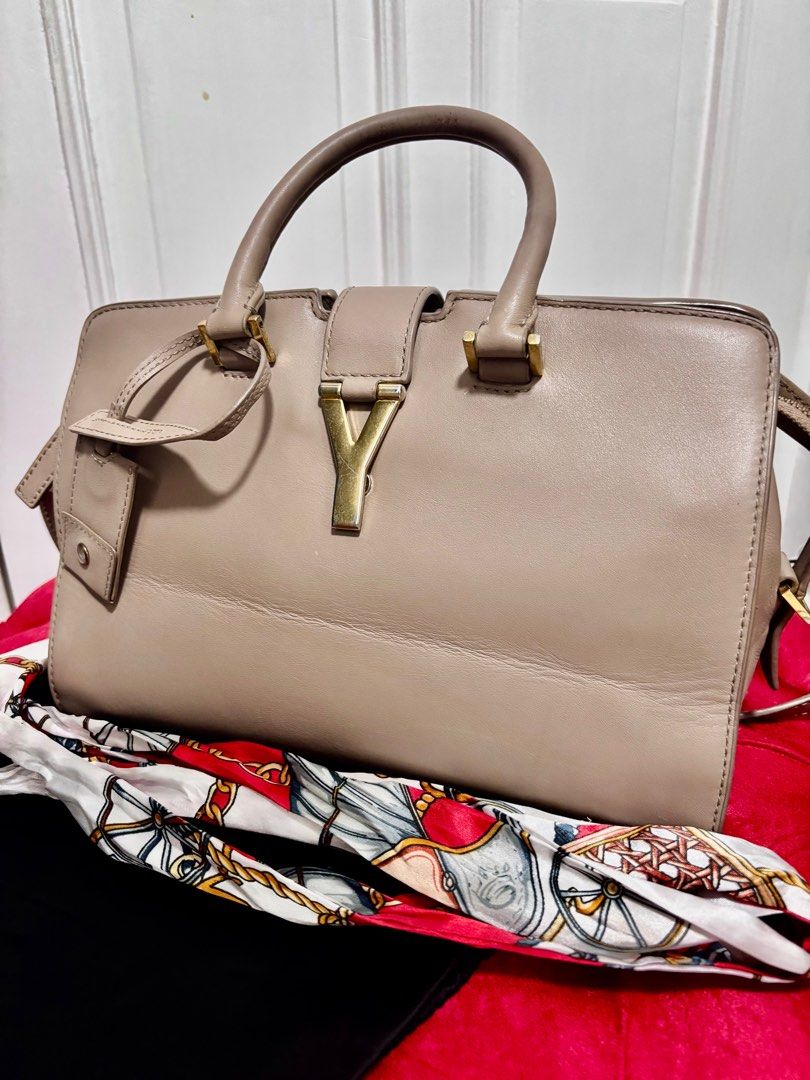 Yves Saint Laurent - Cabas Chyc Classic Y (Category: Luxury Bags & Wallets) located in Quezon City. Submitted by crafted.by.eli (Listing ID 1352265170, Image 2). Description: Selling mom’s Authentic Pre Loved Yves Saint Laurent Cabas Chyc Classic Y Small – Nude Calfskin Leather 👜 🏷️Price: P 19,999 Hard-to-find color! Elegant and versatile 2-way bag. 🔘Condition: Good (No tears, clean interior) 🔘Flaws: Tarnished hardware, creases on the front, 