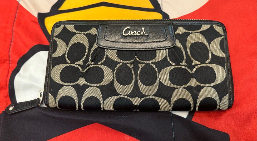 Coach wallet (Category: Luxury Bags & Wallets) located in Quezon City. Submitted by trixieprelovedshop (Listing ID 1352360811, Image 1). Description: Needs cleaning Canvass material This is a preloved item so please manage your expectation.