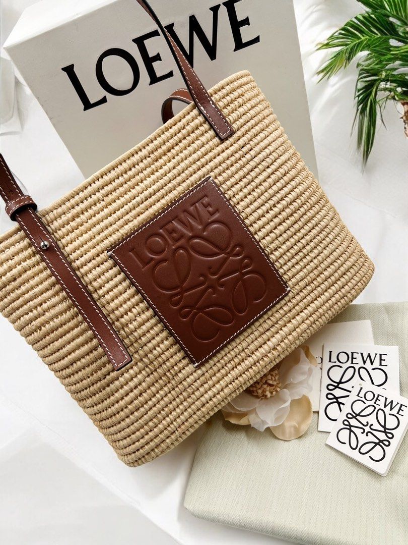 ⚜️Loewe Raffia Small Basket Tote bag (Category: Luxury Bags & Wallets) located in Makati City. Submitted by 90sangel (Listing ID 1352505095, Image 3). Description: •Item: Loewe Raffia Basket Bag 👜 •Size: Small 28cm x 21cm •Condition: Excellent! *Dreaming of an island in the sun? 🌴🏝️✨🫧Can you already hear the waves crashing against the shore? This whimsical basket bag from Loewe imbues the warm, fuzzy feelings of a summer holiday into one hand