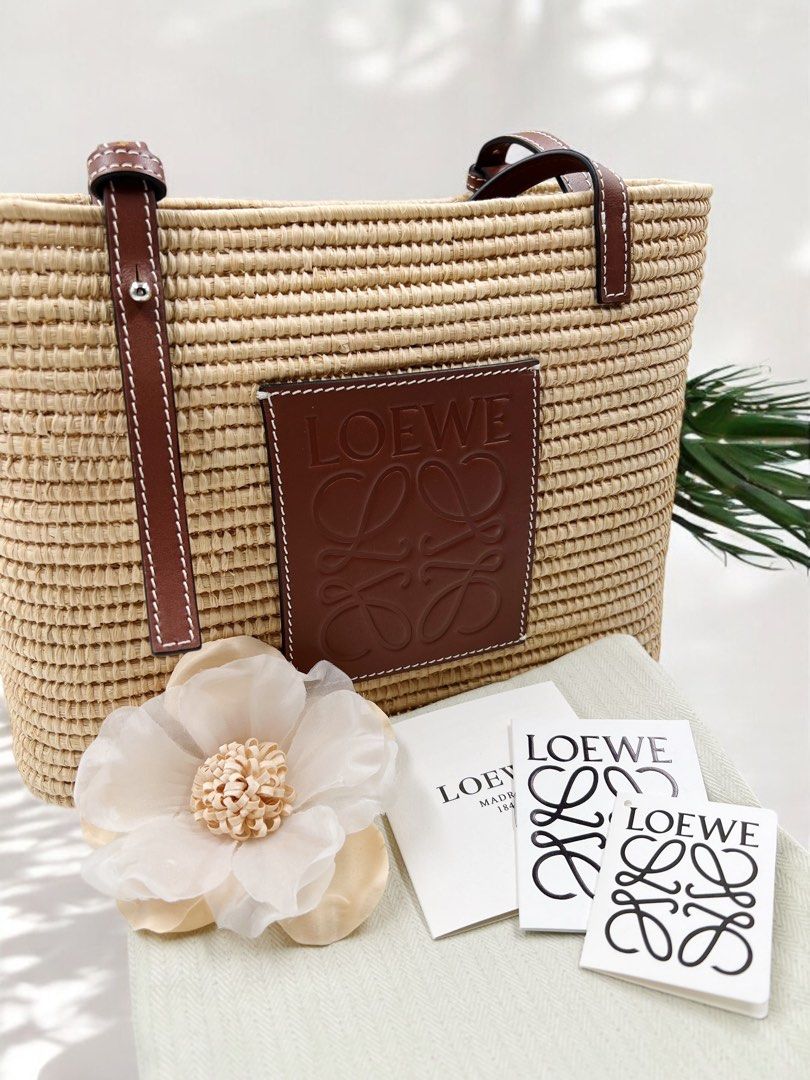 ⚜️Loewe Raffia Small Basket Tote bag (Category: Luxury Bags & Wallets) located in Makati City. Submitted by 90sangel (Listing ID 1352505095, Image 2). Description: •Item: Loewe Raffia Basket Bag 👜 •Size: Small 28cm x 21cm •Condition: Excellent! *Dreaming of an island in the sun? 🌴🏝️✨🫧Can you already hear the waves crashing against the shore? This whimsical basket bag from Loewe imbues the warm, fuzzy feelings of a summer holiday into one hand