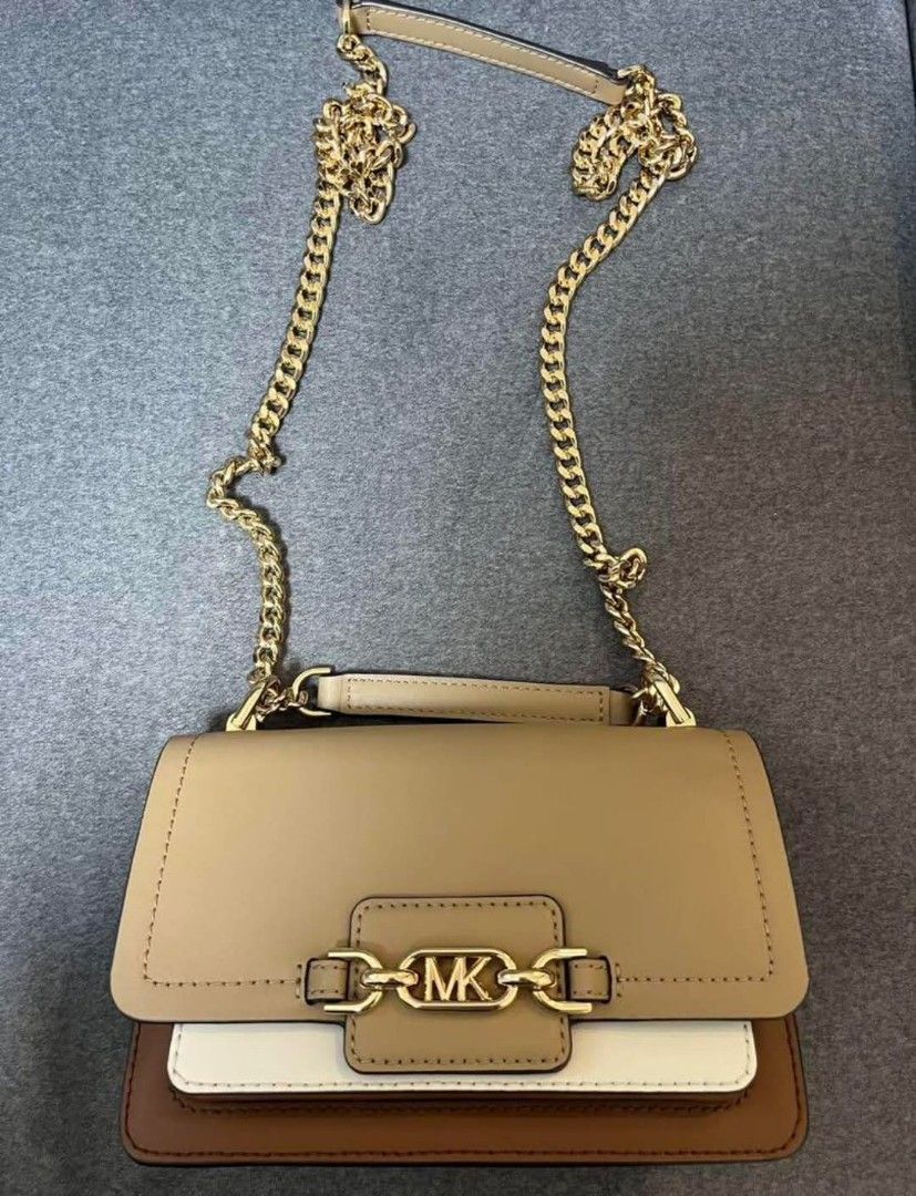 Original MK (Category: Luxury Bags & Wallets) located in Bulacan. Submitted by vintage_purge (Listing ID 1352518094, Image 2). Description: mk 4500php The chain can be worn either short or long. A stylish beige and brown leather shoulder bag with a chain strap. - Color: Beige/Brown/White - Material: Leather - Strap Type: Chain Strap - Interior: Two Compartments lets make reading a habit please ask us before proceeding into transactions we cater t