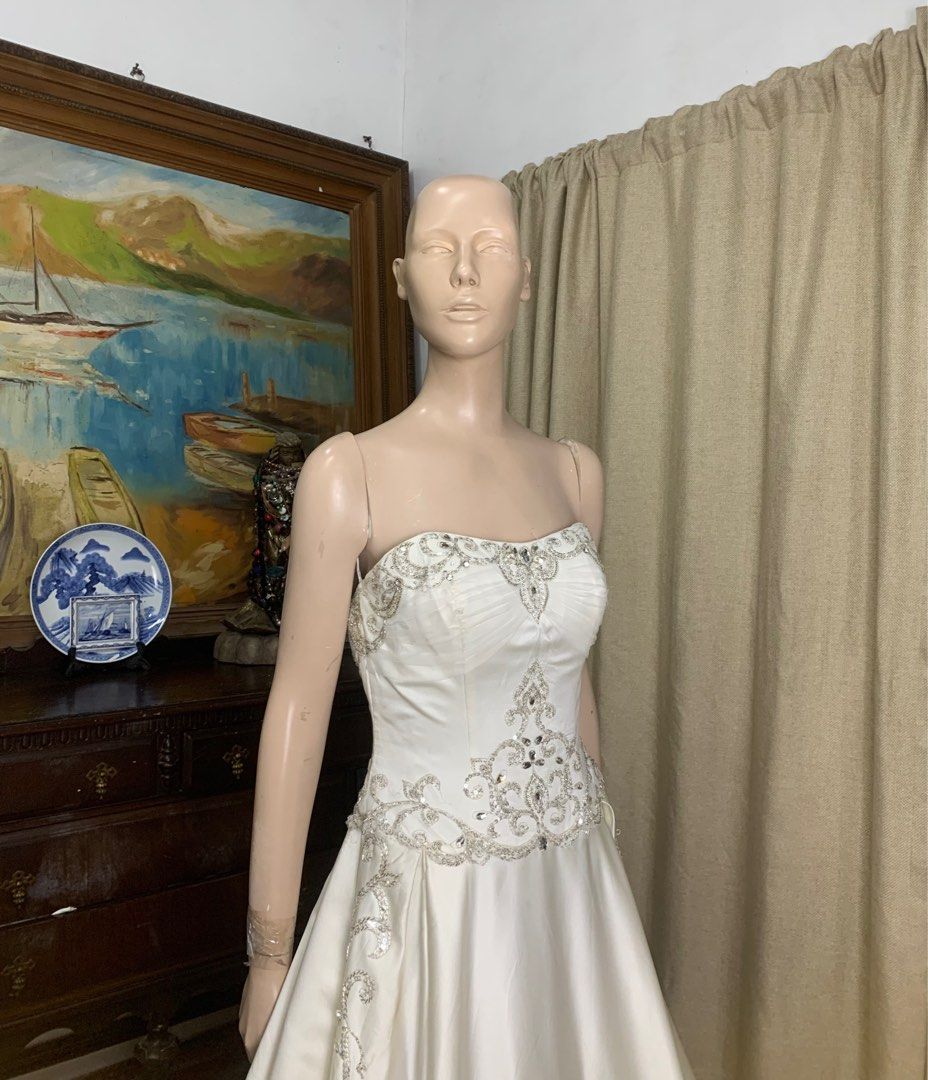 Stunning Embroidered Mikado Wedding Gown (Category: Evening dresses & gowns) located in Carmona. Submitted by fashionlibraryph (Listing ID 1353066704, Image 2). Description: This stunning wedding gown is crafted from luxurious Mikado fabric, offering a structured yet elegant silhouette. The strapless bodice features a subtle sweetheart neckline adorned with intricate silver embroidery and beadwork, accentuating the bust and waistline with a regal